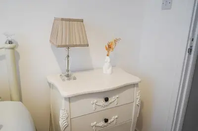 a white nightstand with a lamp on top of it at The Townhouse Liverpool in Liverpool