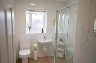 a white bathroom with a toilet and a sink at The Townhouse Liverpool in Liverpool