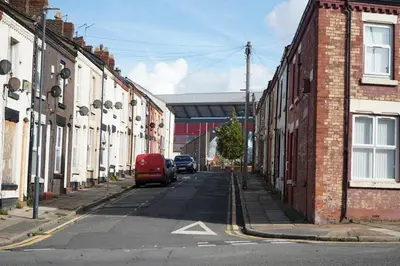 a red van parked on a street with buildings at The Butterfield in Liverpool