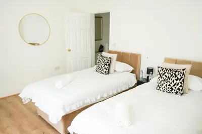two beds in a room with a mirror at The Butterfield in Liverpool