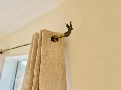 a bronze curtain curtain rod with a deer head on it at The Nest at Heaton Family Friendly Near Preston and Blackpool Ample Parking and WiFi in Kirkham