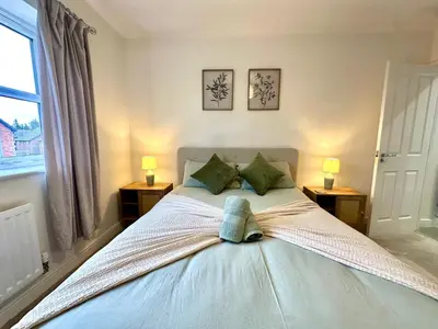 a bedroom with a bed with a hat on it at The Nest at Heaton Family Friendly Near Preston and Blackpool Ample Parking and WiFi in Kirkham