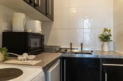 a kitchen with a sink and a microwave at One Bedroom Apartment by Brookland Stays Serviced Accommodation Short Lets Blackpool with Free WiFi in Blackpool