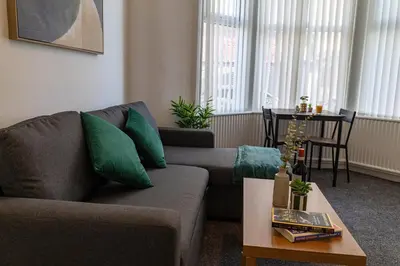 a living room with a couch and a table at One Bedroom Apartment by Brookland Stays Serviced Accommodation Short Lets Blackpool with Free WiFi in Blackpool