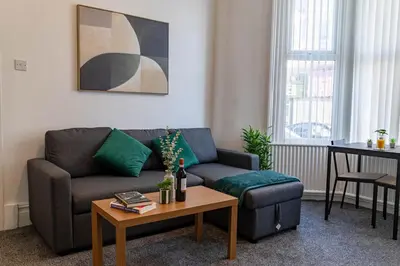 a living room with a couch and a table at One Bedroom Apartment by Brookland Stays Serviced Accommodation Short Lets Blackpool with Free WiFi in Blackpool