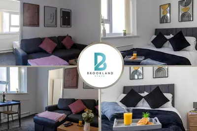 a room with a bed and a couch and a table at One Bedroom Apartment by Brookland Stays Serviced Accommodation Short Lets Blackpool with Free WiFi in Blackpool