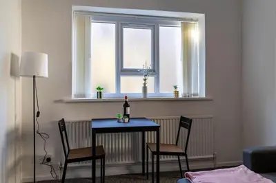 a table and two chairs in a room with a window at One Bedroom Apartment by Brookland Stays Serviced Accommodation Short Lets Blackpool with Free WiFi in Blackpool