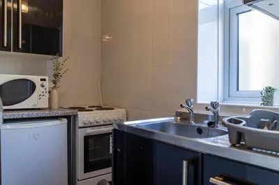 a kitchen with a sink and a microwave at One Bedroom Apartment by Brookland Stays Serviced Accommodation Short Lets Blackpool with Free WiFi in Blackpool