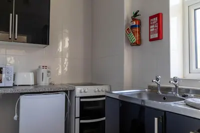 a kitchen with a sink and a stove at One Bedroom Apartment by Brookland Stays Serviced Accommodation Short Lets Blackpool with Free WiFi in Blackpool