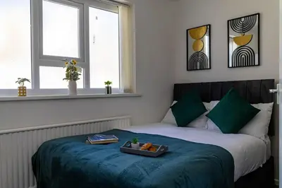 a bedroom with a bed with a tray of food on it at One Bedroom Apartment by Brookland Stays Serviced Accommodation Short Lets Blackpool with Free WiFi in Blackpool