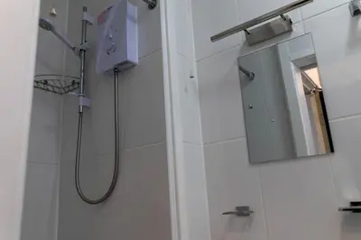 a bathroom with a shower and a mirror at One Bedroom Apartment by Brookland Stays Serviced Accommodation Short Lets Blackpool with Free WiFi in Blackpool