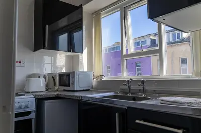 a kitchen with a sink and a microwave at One Bedroom Flat by Brookland Stays Serviced Accommodation Short Lets Blackpool with Free WiFi in Blackpool