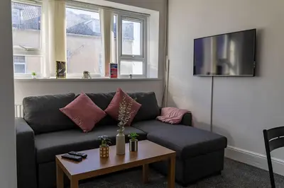 a living room with a couch and a table at Brookland Stays Blackpool 1BR Apartment Sleeps 4 WiFi in Blackpool