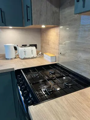 a kitchen counter with a stove and a toaster at Modern Caravan 2025 with Decking in Morecambe