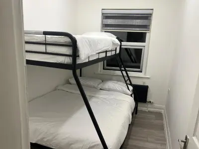 two bunk beds in a room with a window at Seaside Escape in Blackpool in Blackpool