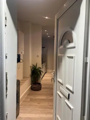a hallway with a door and a potted plant at Seaside Escape in Blackpool in Blackpool