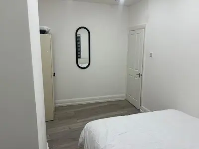 a bedroom with a bed and a mirror on the wall at Seaside Escape in Blackpool in Blackpool