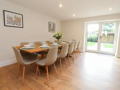 a dining room with a wooden table and chairs at Alston House in Preston