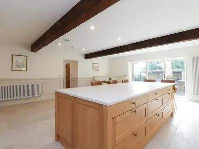 a kitchen with a large island with white counter top at Alston House in Preston
