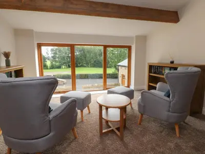 a living room with two chairs and a table at Alston House in Preston