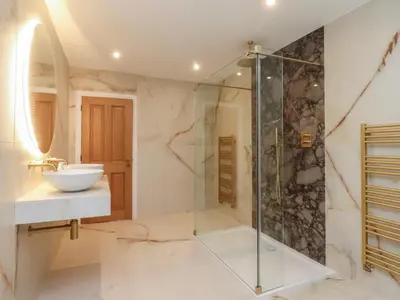 a bathroom with a glass shower and a sink at Alston House in Preston