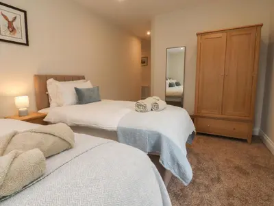 a bedroom with two beds with towels on them at Alston House in Preston