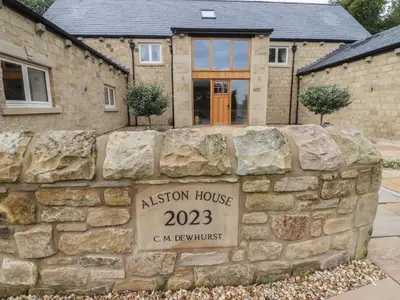a stone wall in front of a house at Alston House in Preston