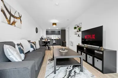 a living room with a couch and a table at 2BR Apt - City Centre - Parking - Balcony - Long Stays - Contractors in Liverpool