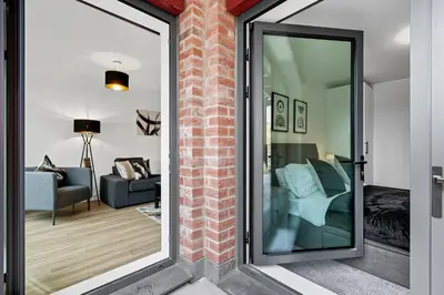 a room with a glass door leading to a living room at 2BR Apt - City Centre - Parking - Balcony - Long Stays - Contractors in Liverpool