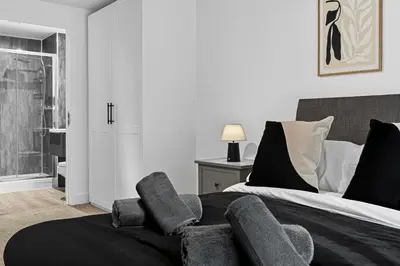 a bedroom with a bed with a chair in it at 2BR Apt - City Centre - Parking - Balcony - Long Stays - Contractors in Liverpool