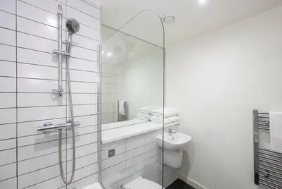 a bathroom with a glass shower and a sink at Contemporary 1BED Apartment in Liverpool w Balcony in Liverpool