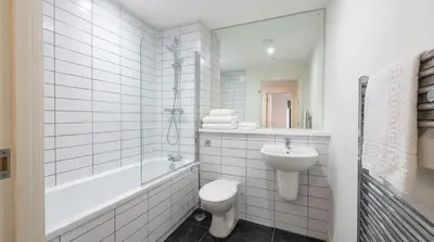 a white bathroom with a toilet and a sink at Contemporary 1BED Apartment in Liverpool w Balcony in Liverpool