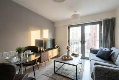 a living room with a couch and a table at Contemporary 1BED Apartment in Liverpool w Balcony in Liverpool