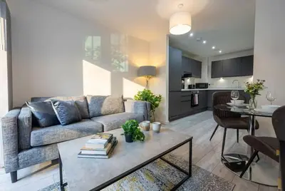 a living room with a couch and a table at Contemporary 1BED Apartment in Liverpool w Balcony in Liverpool