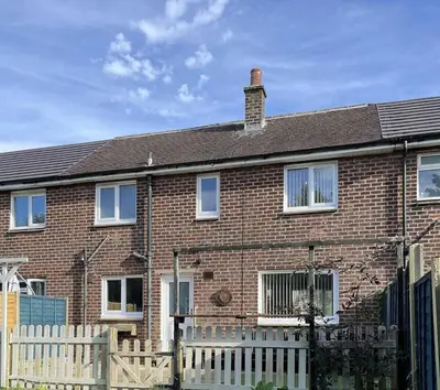 a brick house with a white fence in front of it at Modern 3-bed house with parking - Chorley Near M61 in Heapey