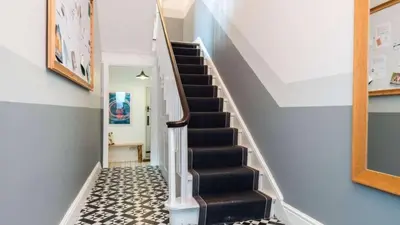 a staircase with a black and white tile floor at Georgian Residence - 4BR Modern Living, Sleeps 8! in Liverpool