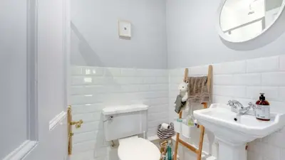 a white bathroom with a toilet and a sink at Georgian Residence - 4BR Modern Living, Sleeps 8! in Liverpool
