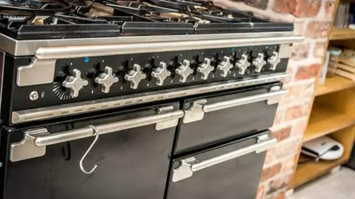 a black stove with a bunch of knobs on it at Georgian Residence - 4BR Modern Living, Sleeps 8! in Liverpool