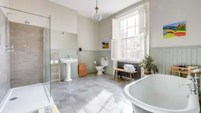 a bathroom with a tub and a toilet and a sink at Georgian Residence - 4BR Modern Living, Sleeps 8! in Liverpool