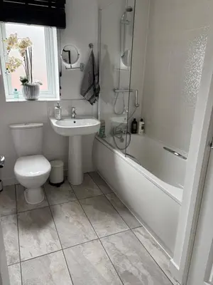 a bathroom with a toilet and a tub and a sink at Modern Detached House with multiple parking and large garden next to Anfield Stadium in Liverpool