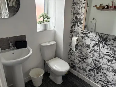 a bathroom with a toilet and a sink at Modern Detached House with multiple parking and large garden next to Anfield Stadium in Liverpool