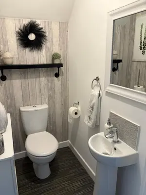 a bathroom with a toilet and a sink at Modern Detached House with multiple parking and large garden next to Anfield Stadium in Liverpool