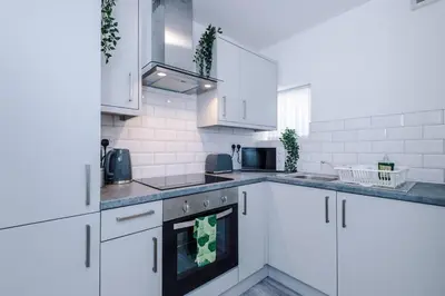 a kitchen with white cabinets and a stove top oven at Walkable distance to LFC & EFC Stadiums in Liverpool
