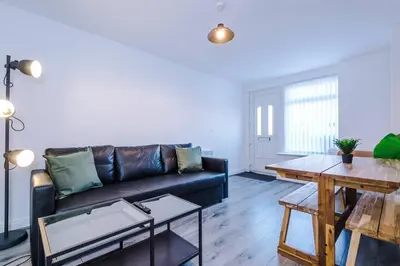 a living room with a couch and a table at Walkable distance to LFC & EFC Stadiums in Liverpool