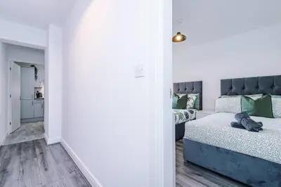 a bedroom with a bed with a blue headboard at Walkable distance to LFC & EFC Stadiums in Liverpool