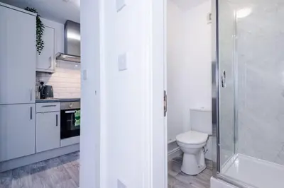 a bathroom with a toilet and a glass shower at Walkable distance to LFC & EFC Stadiums in Liverpool