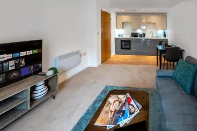 a living room with a couch and a table at Modern Downtown Gem- Brand New Apartments on Cannon St in Preston