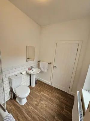 a bathroom with a toilet and a sink at Kings Central 3 Bedroom, free parking & Wifi, dog friendly in Southport