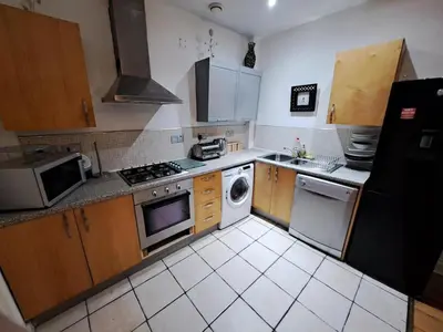a kitchen with a stove and a dishwasher at City-center Flat Sleeps 4 with Balcony in Liverpool