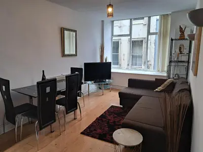 a living room with a couch and a table at City-center Flat Sleeps 4 with Balcony in Liverpool